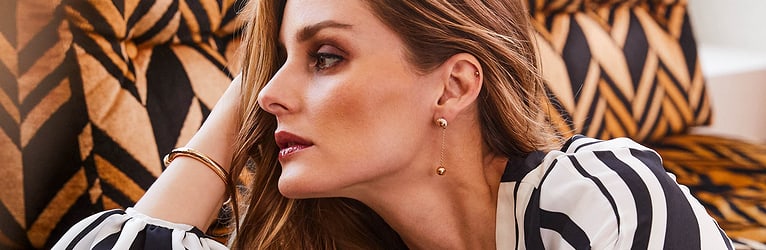 Olivia Palermo wearing gold diamond bangle bracelets and luxury earrings