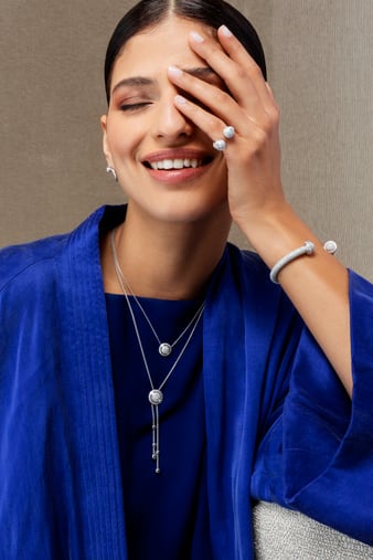 A woman matching a diamond open ring with a white gold diamond bangle bracelet